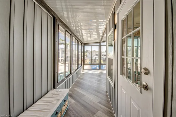 Unfurnished sunroom with wood finished floors