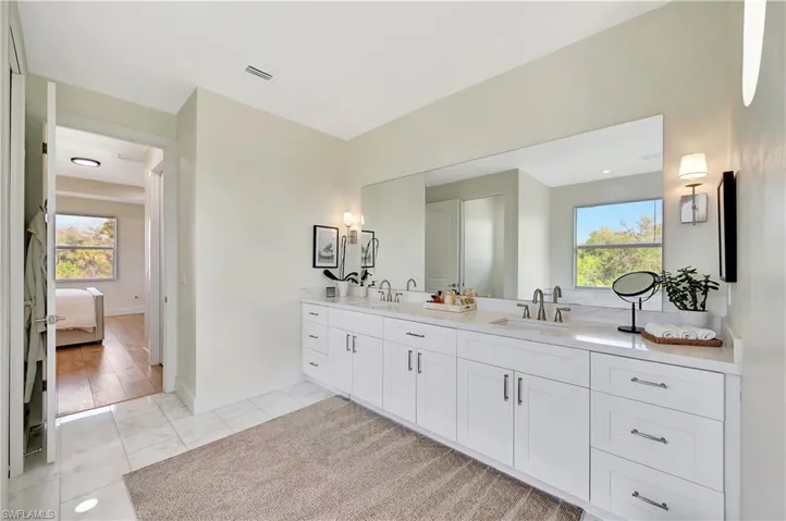 Bathroom with vanity, a healthy amount of sunlight