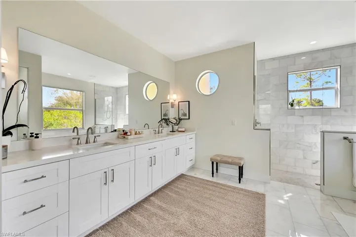 Bathroom with vanity, a marble shower