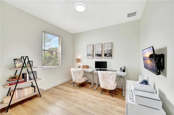 Office area/bedroom featuring light hardwood / wood-style flooring