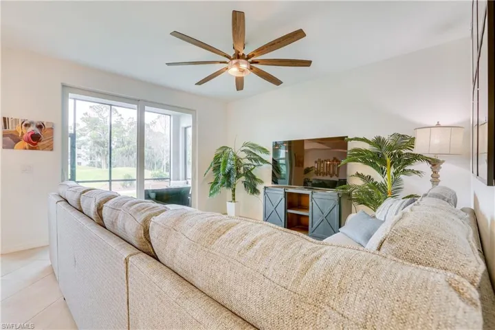 Living room featuring tile patterned flooring and ceiling fan