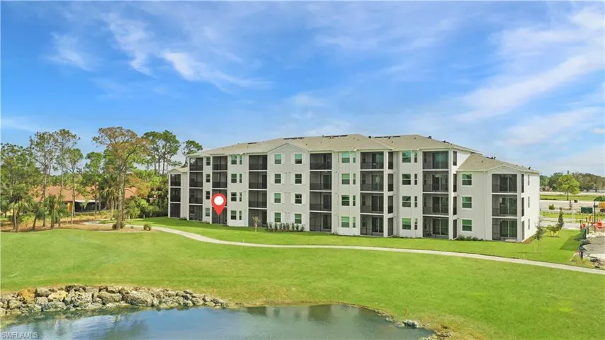 View of apartment building / complex featuring a water view