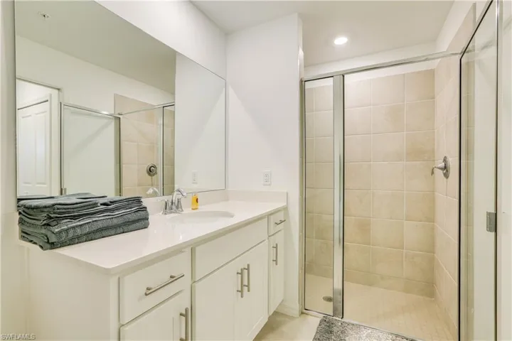 Bathroom with vanity and a stall shower