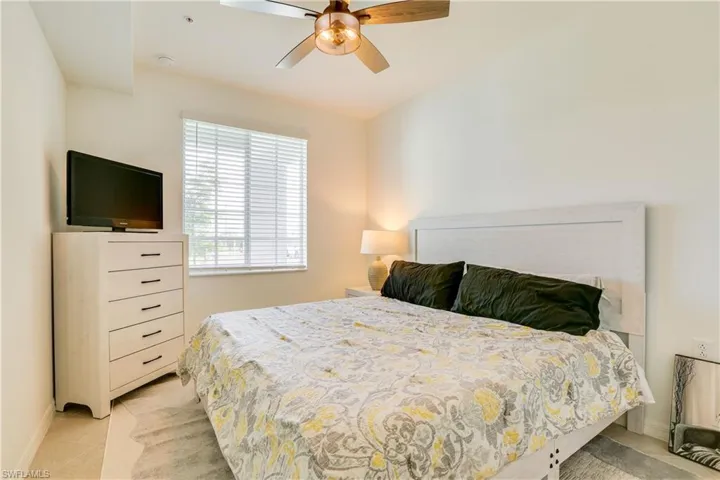 Bedroom featuring a ceiling fan and light tile patterned flooring