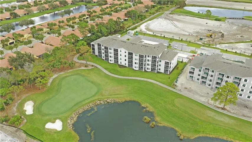 View of property location featuring a nearby body of water and a golf course