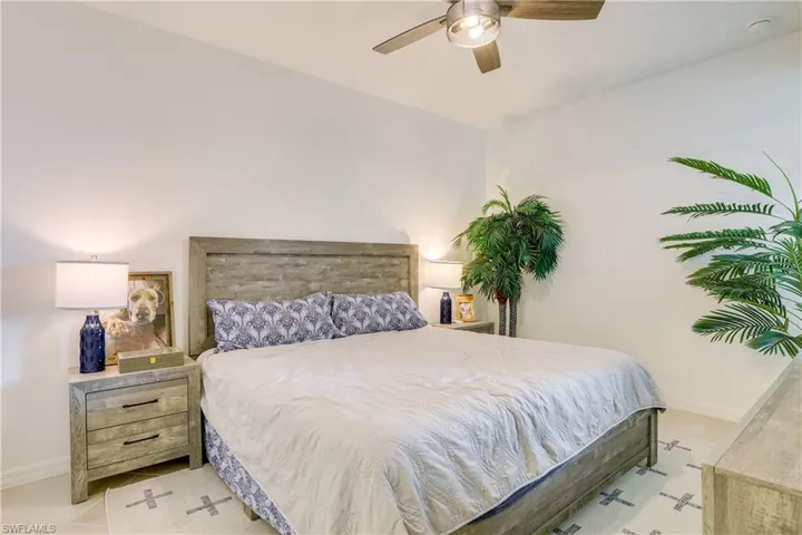 Bedroom featuring a ceiling fan and light tile patterned flooring