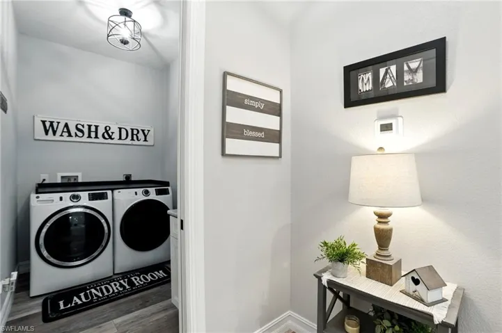 Laundry room featuring wood finished floors and separate washer and dryer