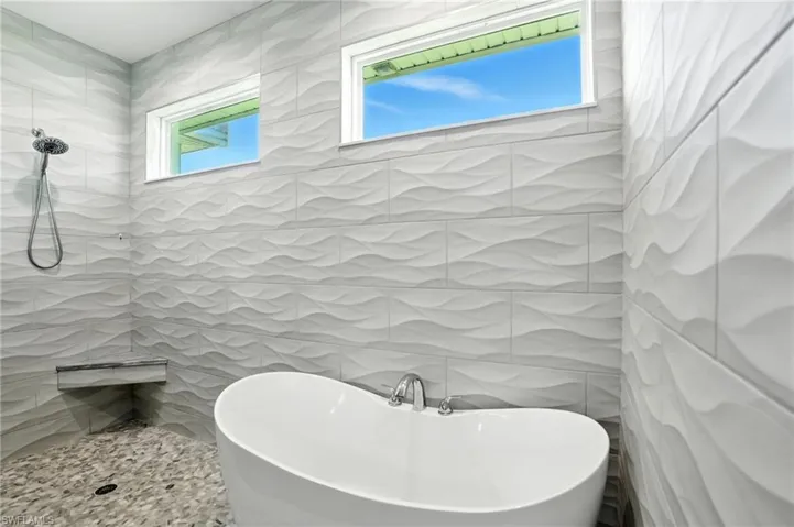 Full bath with a tile shower and a freestanding bath