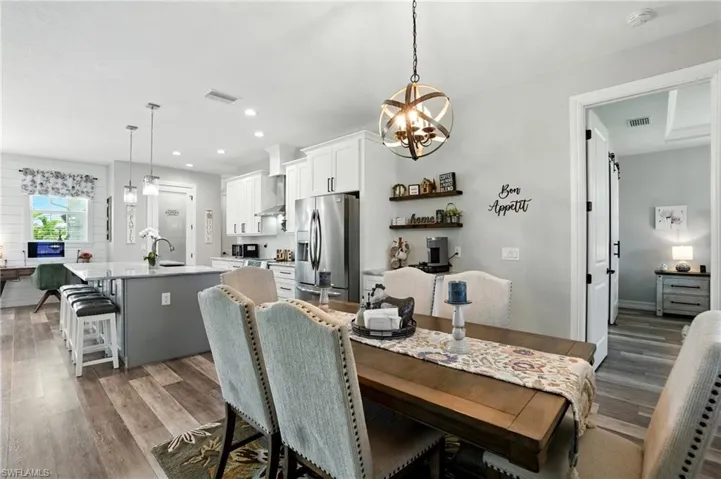 Dining room featuring dark wood finished floors, a chandelier, and recessed lighting