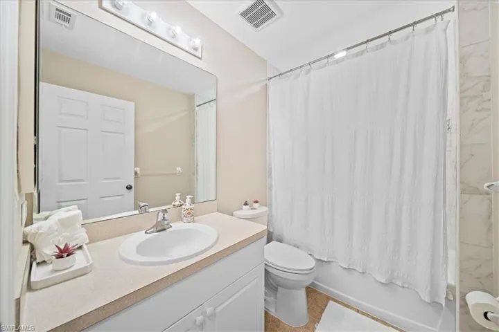 Bathroom featuring vanity and shower / bath combo