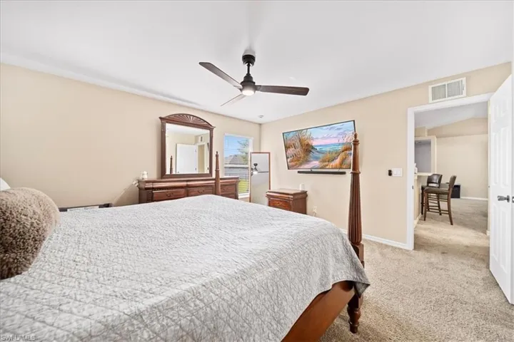 Bedroom featuring light colored carpet and a ceiling fan