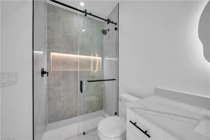 Bathroom with vanity and a shower stall