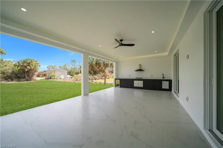 View of patio / terrace with ceiling fan and wine cooler