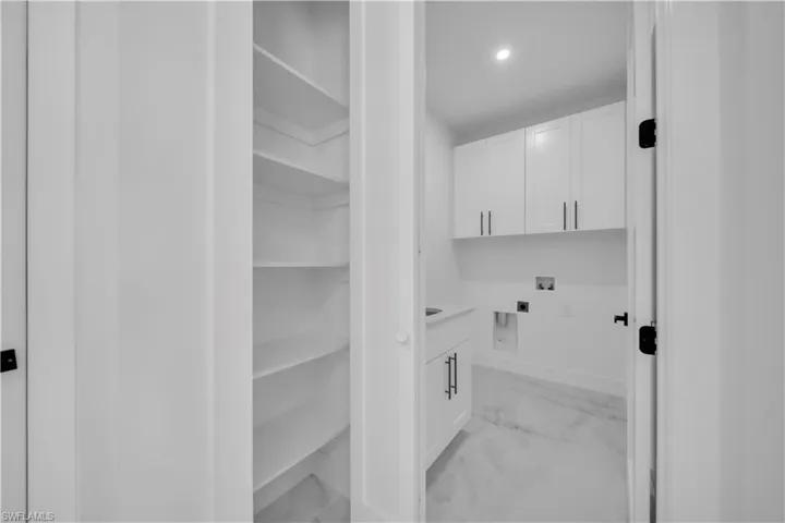Laundry area featuring cabinet space, washer hookup, recessed lighting, and hookup for an electric dryer