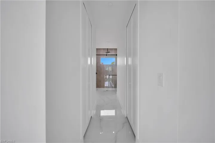 Corridor with light marble finish floors