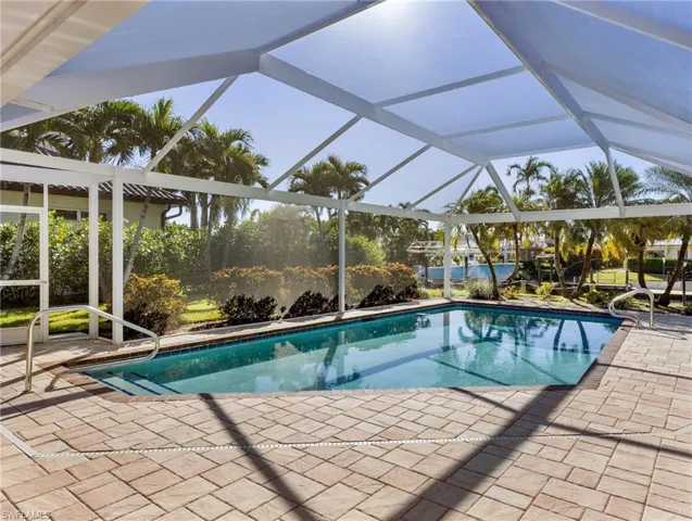 Pool overlooks a beautifully landscaped yard