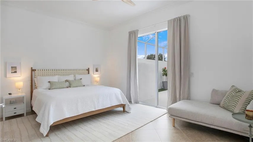 Bedroom featuring ceiling fan, access to exterior, crown molding, and light tile patterned floors