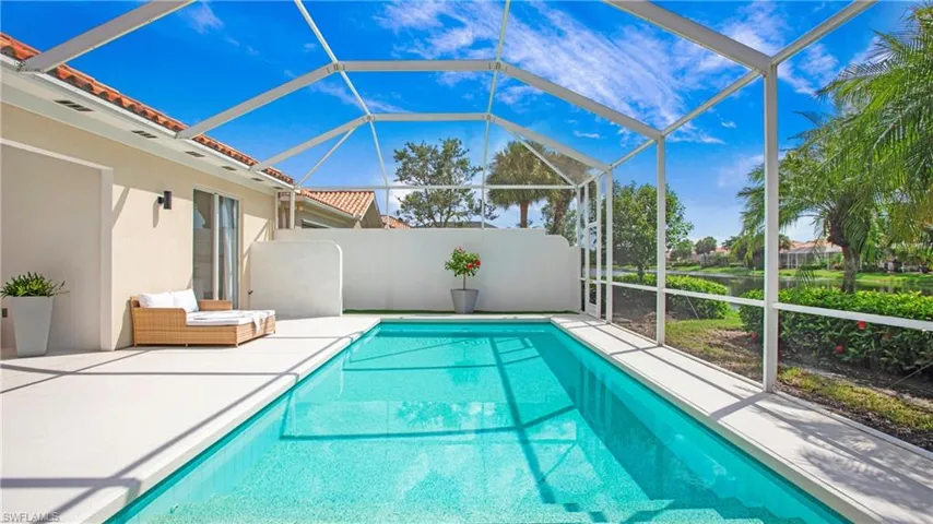 View of pool with a patio and a lanai