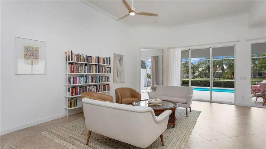 Sitting room featuring crown molding, a high ceiling, ceiling fan, and a wealth of natural light