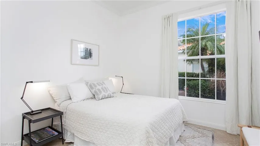 Tiled bedroom featuring ornamental molding