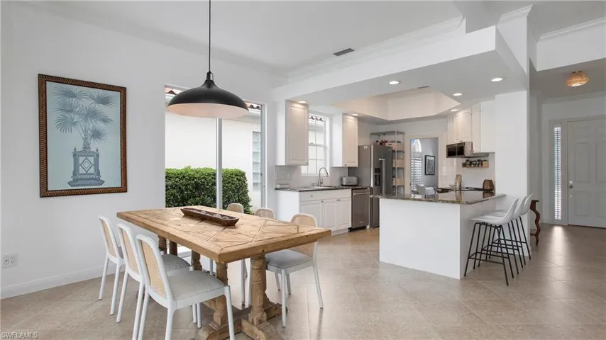 Dining space with ornamental molding and sink