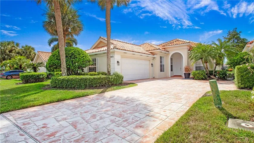 Mediterranean / spanish house with a garage and a front yard