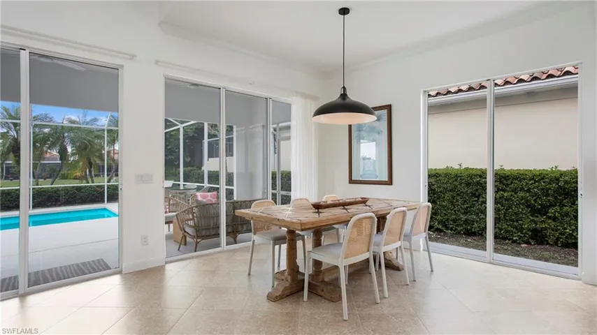 Dining space featuring ornamental molding and light tile patterned floors