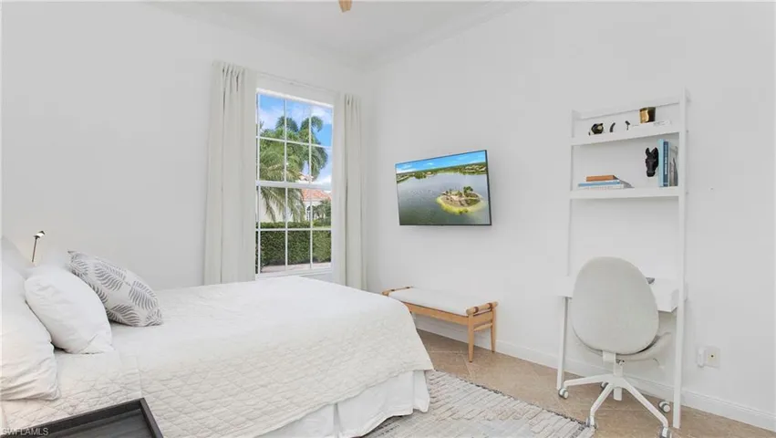 Bedroom with ceiling fan and crown molding