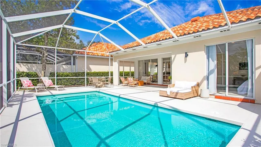 View of pool with a lanai, french doors, and a patio area