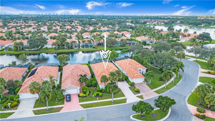 Birds eye view of property with a water view