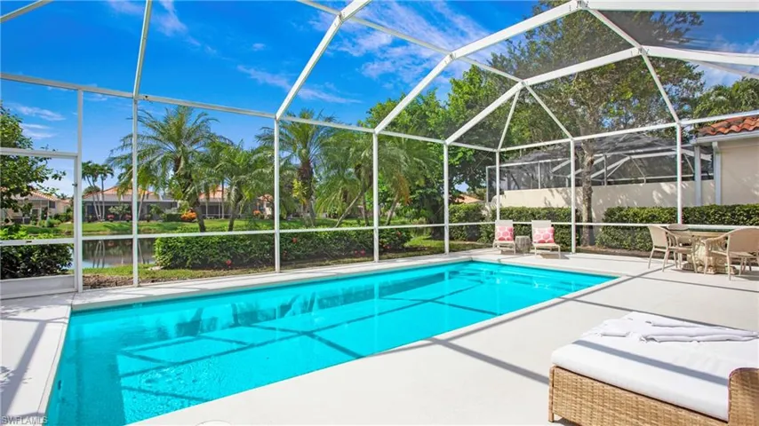 View of swimming pool with a lanai, a water view, and a patio