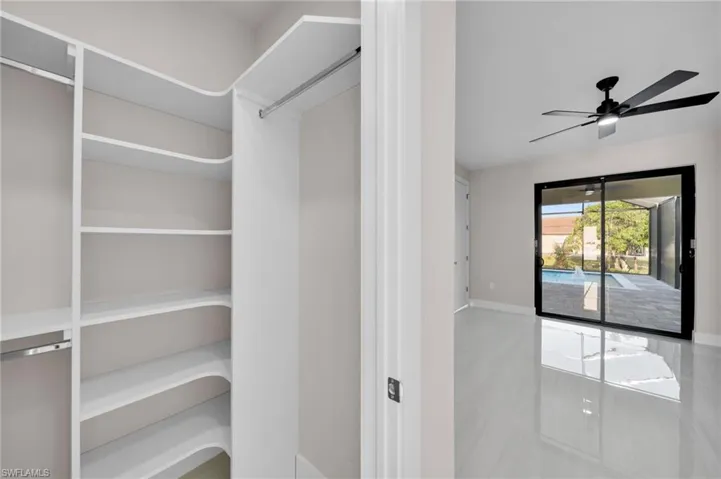 Walk in closet featuring ceiling fan