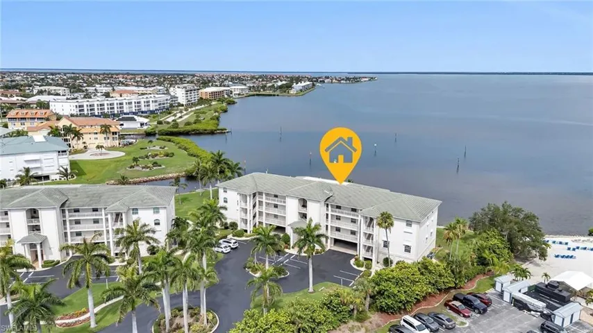 Drone / aerial view of apartment complex and a nearby body of water