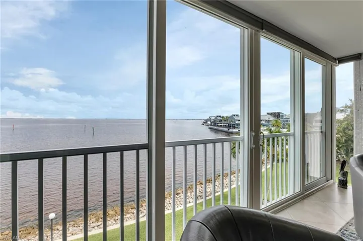 Sunroom / solarium featuring a water view