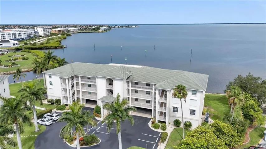 Bird's eye view of apartment complex and a nearby body of water