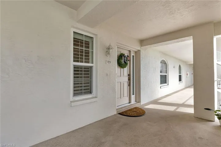 Entrance to property with stucco siding