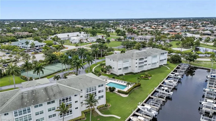 Bird's eye view of a nearby body of water and a pool area