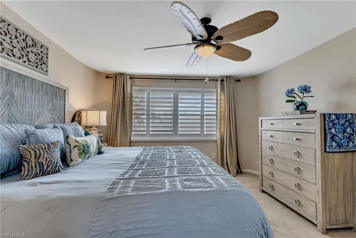 Carpeted bedroom with ceiling fan