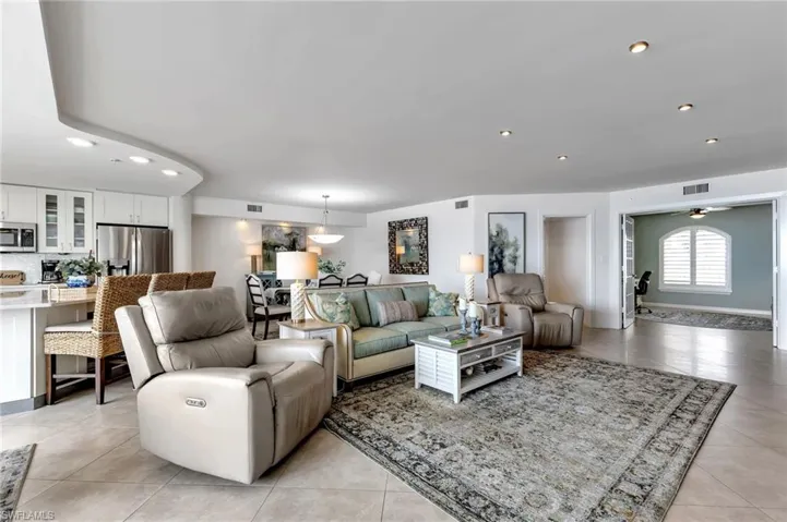 Living room with recessed lighting, light tile patterned floors, and ceiling fan