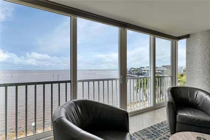 Sunroom / solarium featuring a water view
