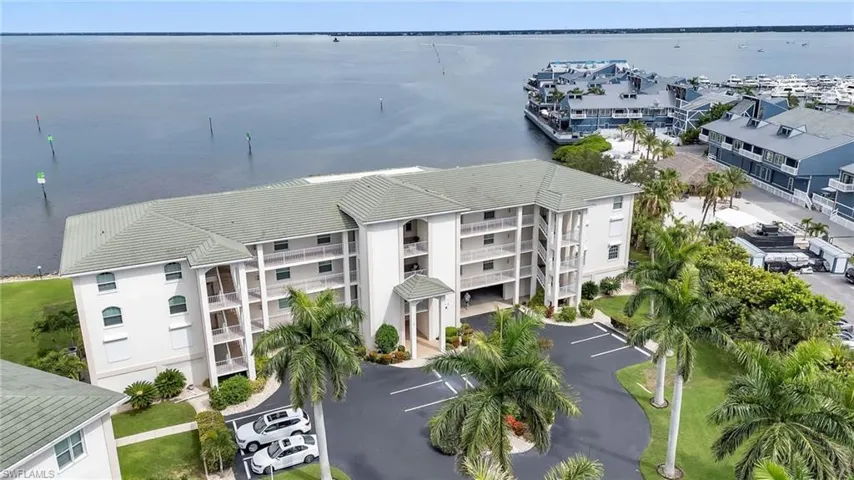 Drone / aerial view of apartment complex and a large body of water