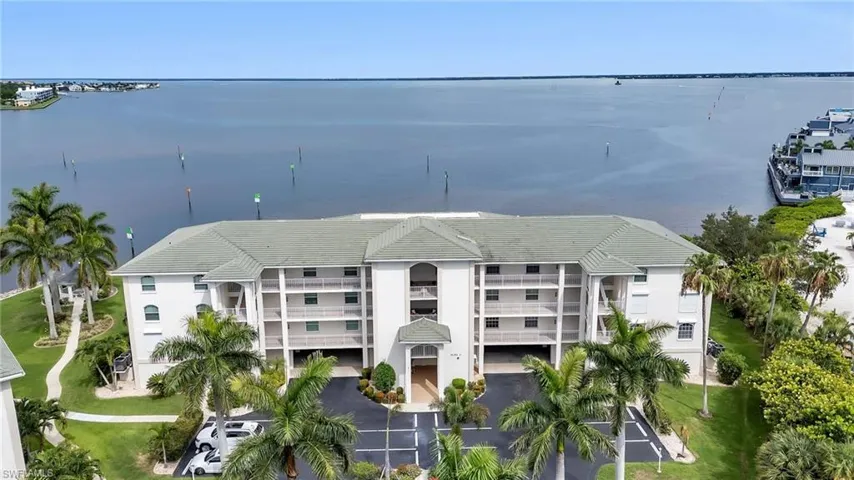 View of apartment building / complex featuring a water view