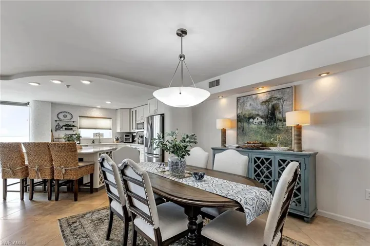 Dining area featuring recessed lighting and light tile patterned flooring
