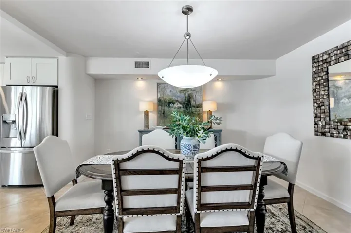 Dining room featuring light tile patterned flooring and baseboards