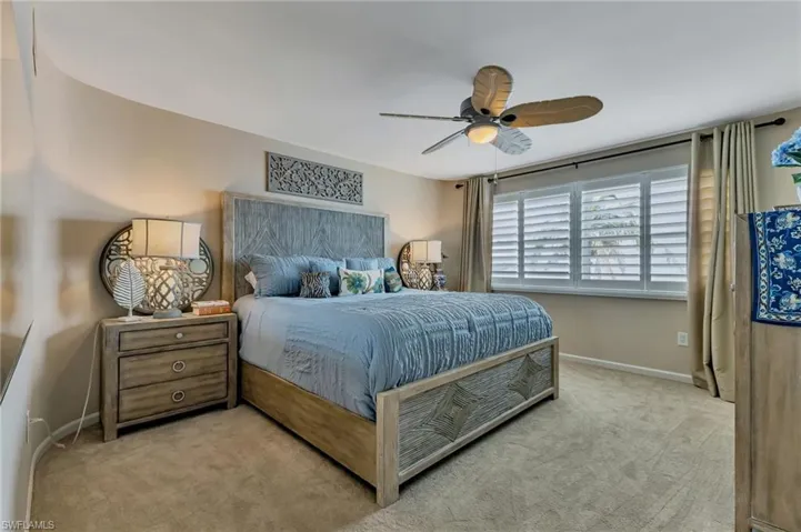 Bedroom featuring ceiling fan and carpet