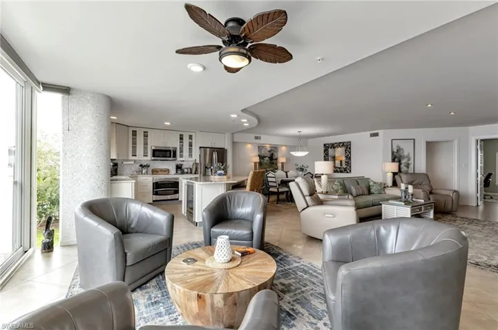 Living area with a ceiling fan, recessed lighting, and light tile patterned floors