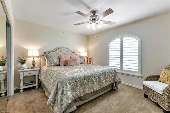 Bedroom featuring light carpet and ceiling fan
