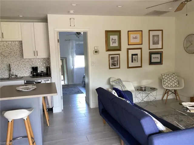Living room with wood-type flooring and sink