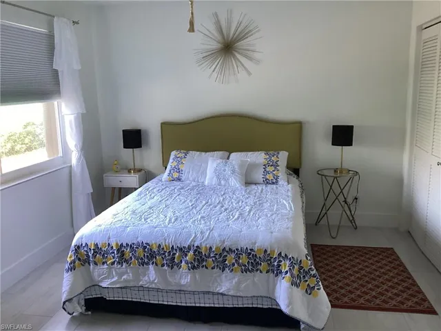 Bedroom with hardwood / wood-style flooring and a closet
