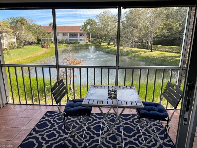Sunroom / solarium with a water view and a wealth of natural light